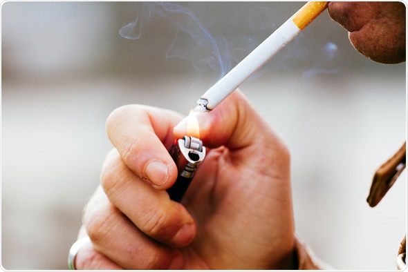 Smoker lighting a cigarette