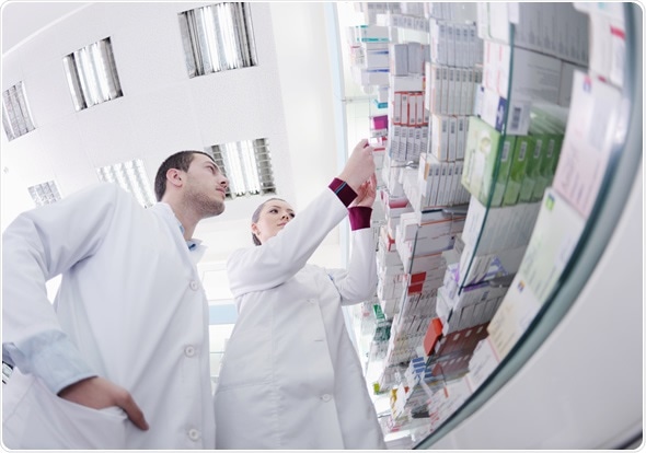 Team of pharmacist chemist woman and man group standing in pharmacy drugstore - Image Copyright: dotshock / Shutterstock