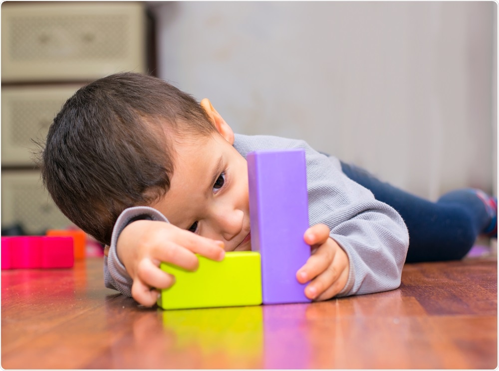 Child with autism playing with building blocks