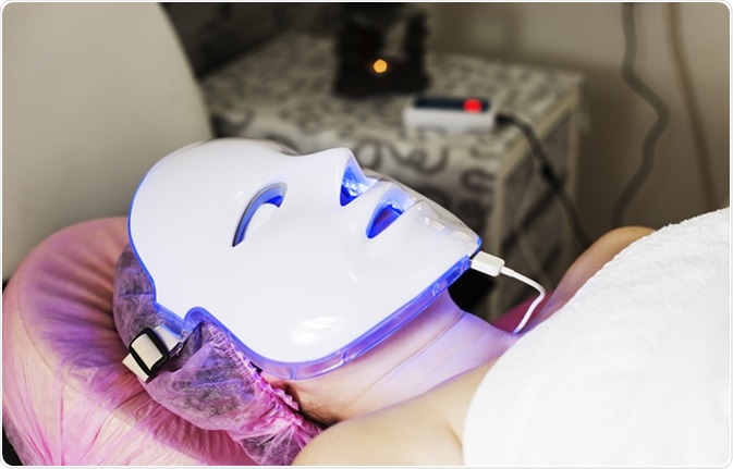 Photodynamic therapy facial mask on woman