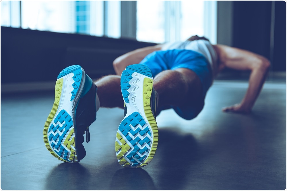 Rear view man doing push up