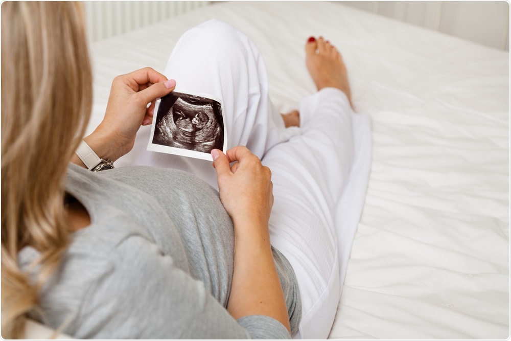 Woman looking at baby scan