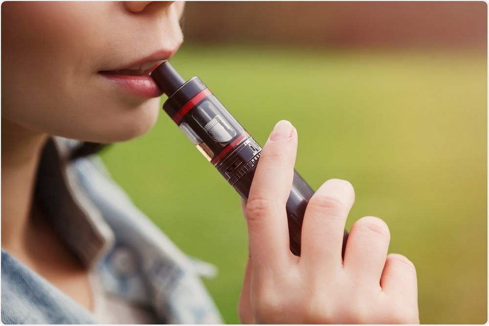 Woman smoking e-cigarette or vape