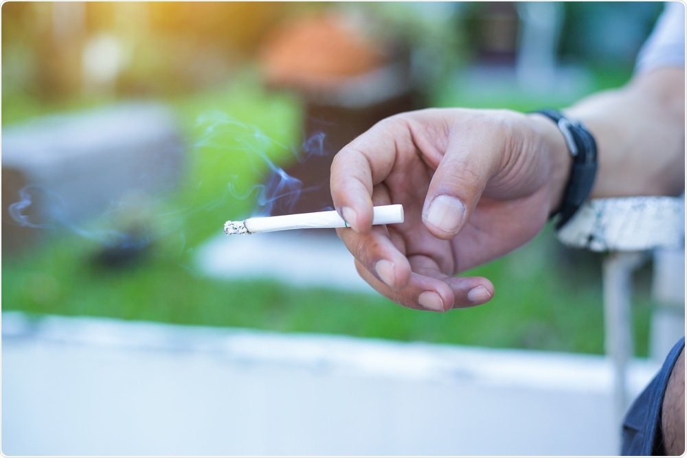 Man smoking regular cigarette