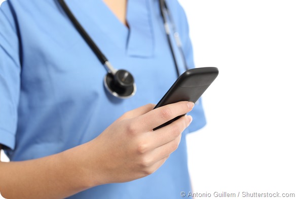Close up of a nurse hand using a smart phone isolated on a white background