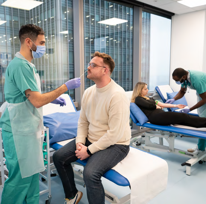 A research doctor takes a swab of a patient