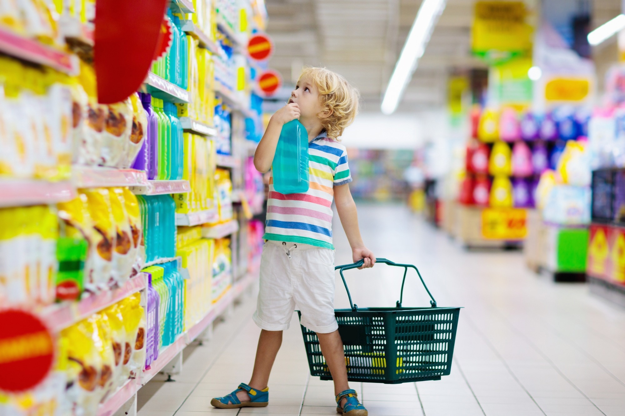 Child in supermarket buying fruit and juice