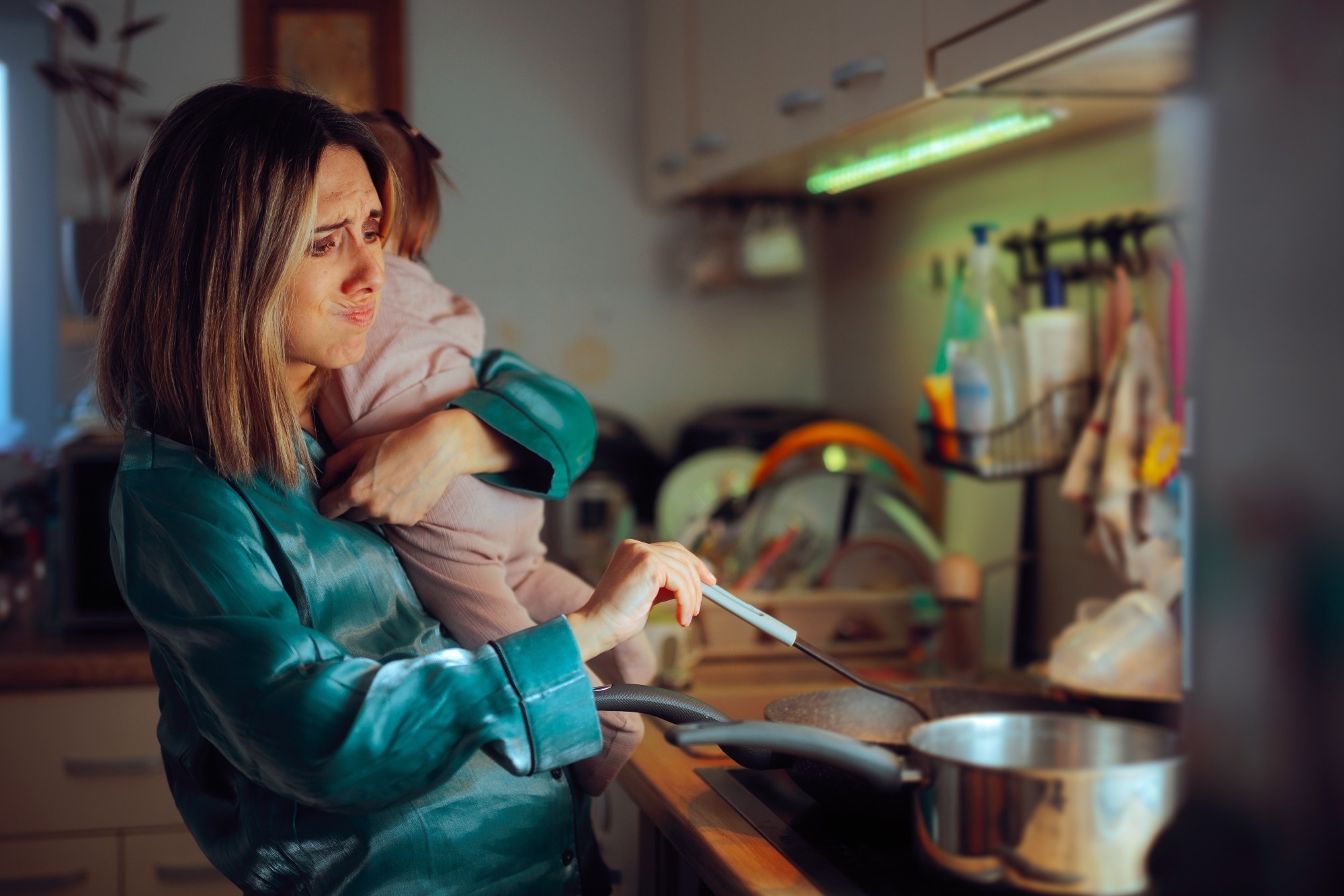 Busy Mom Holds Baby While Preparing Meal in Kitchen
