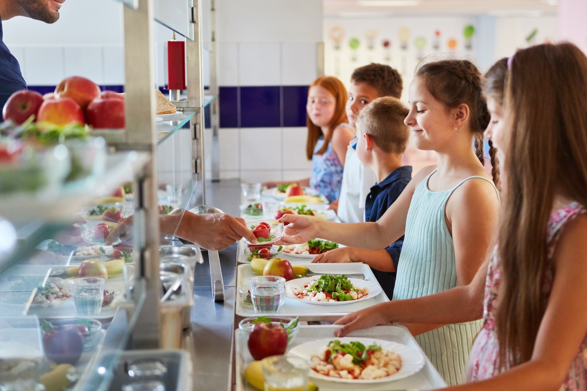 Group of children as elementary students at buffet line,